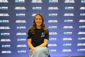 Katie Zelem in front of a promotional backdrop