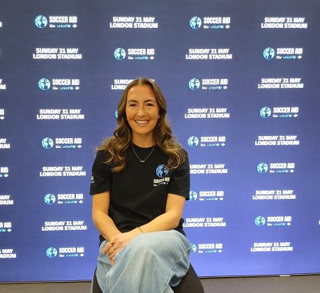 Katie Zelem in front of a promotional backdrop