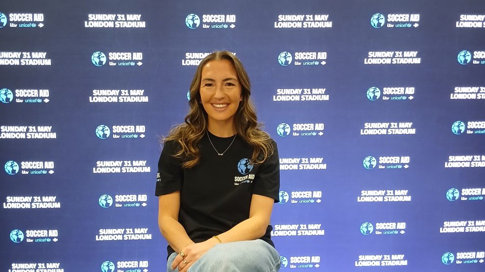 Katie Zelem in front of a promotional backdrop