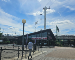 A restaurant with a paved walkway in the foreground