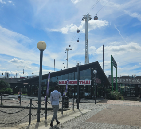 A restaurant with a paved walkway in the foreground