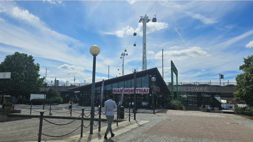 A restaurant with a paved walkway in the foreground