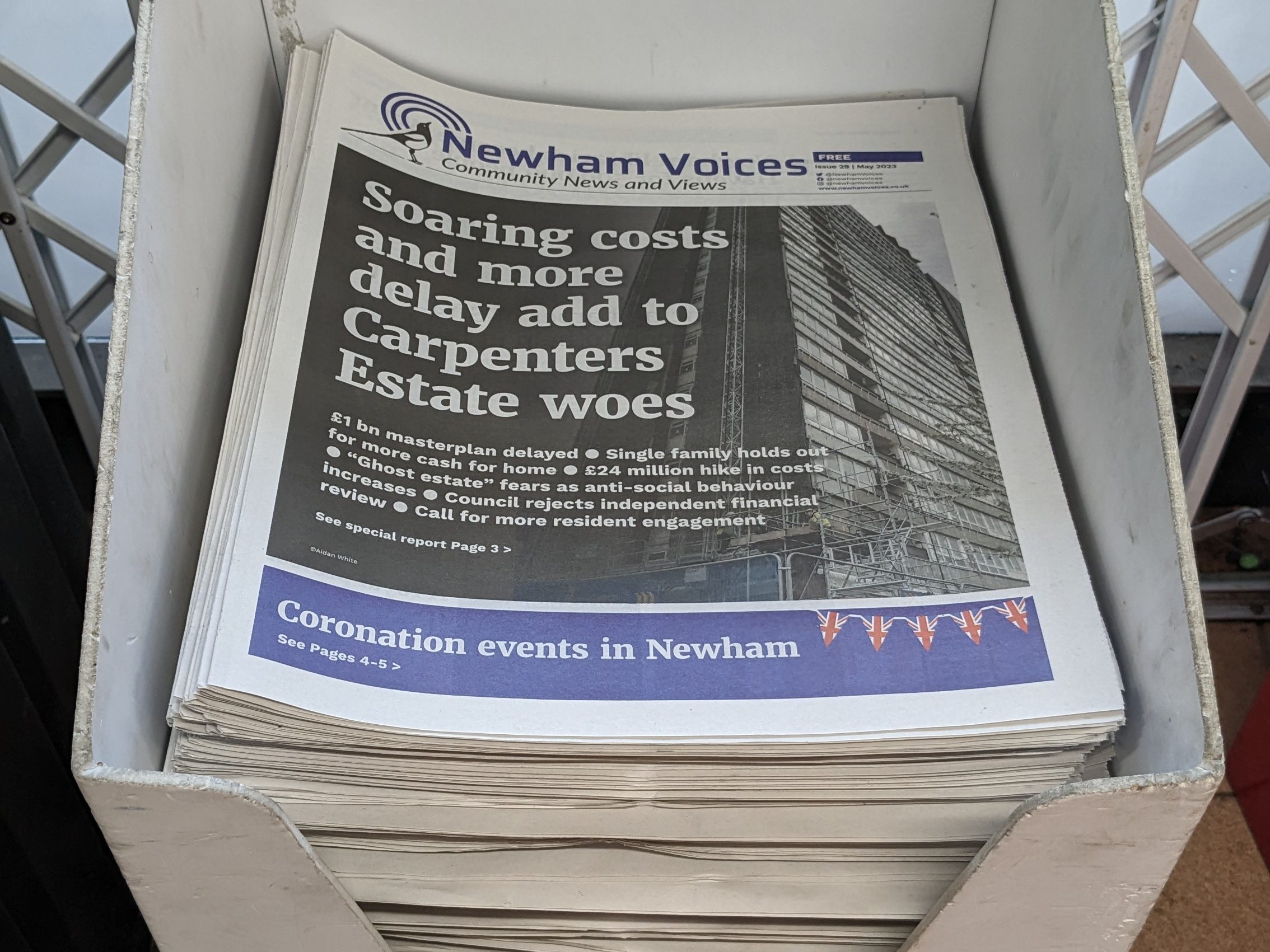 Printed Newham Voices newspapers in a display stand